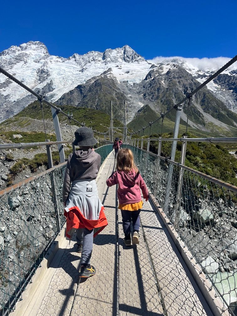 kids crossing a swing bridge