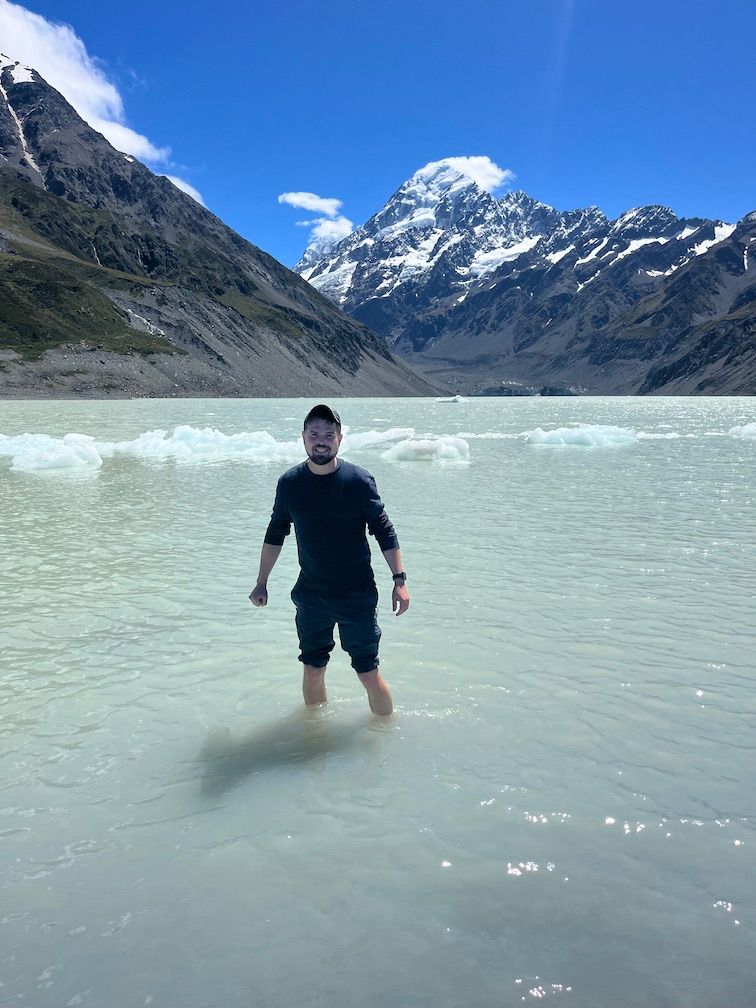 Aaron wading in the glacier lake