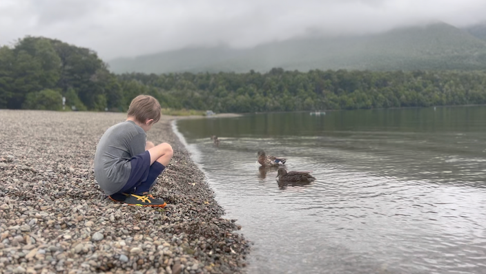 Sitting on the edge of Rotoiti Lake