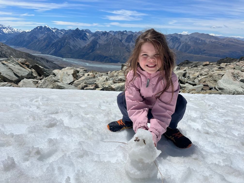 Daughter with her snowman, Olive